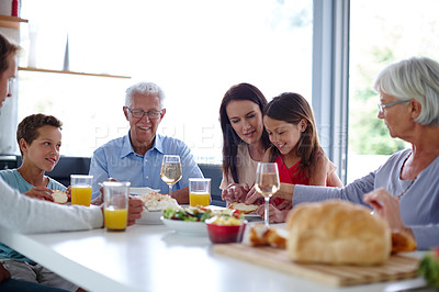 Buy stock photo Shot of a happy multi-generational family having a meal together