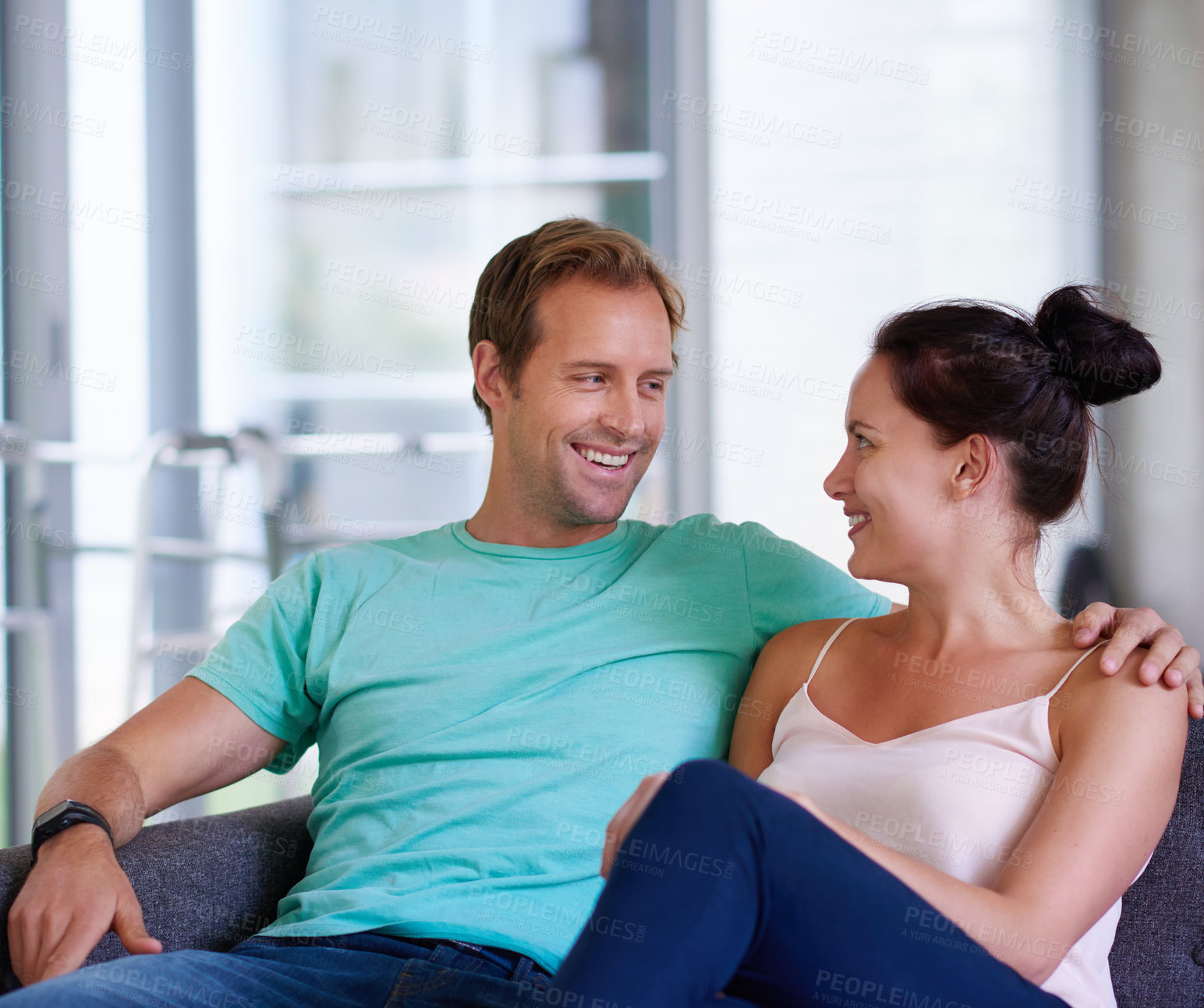 Buy stock photo Sofa, couple and love with smile for bonding, connection and healthy relationship with trust at home. Happy people, man and woman with embrace for marriage, admiration or commitment with hug in house