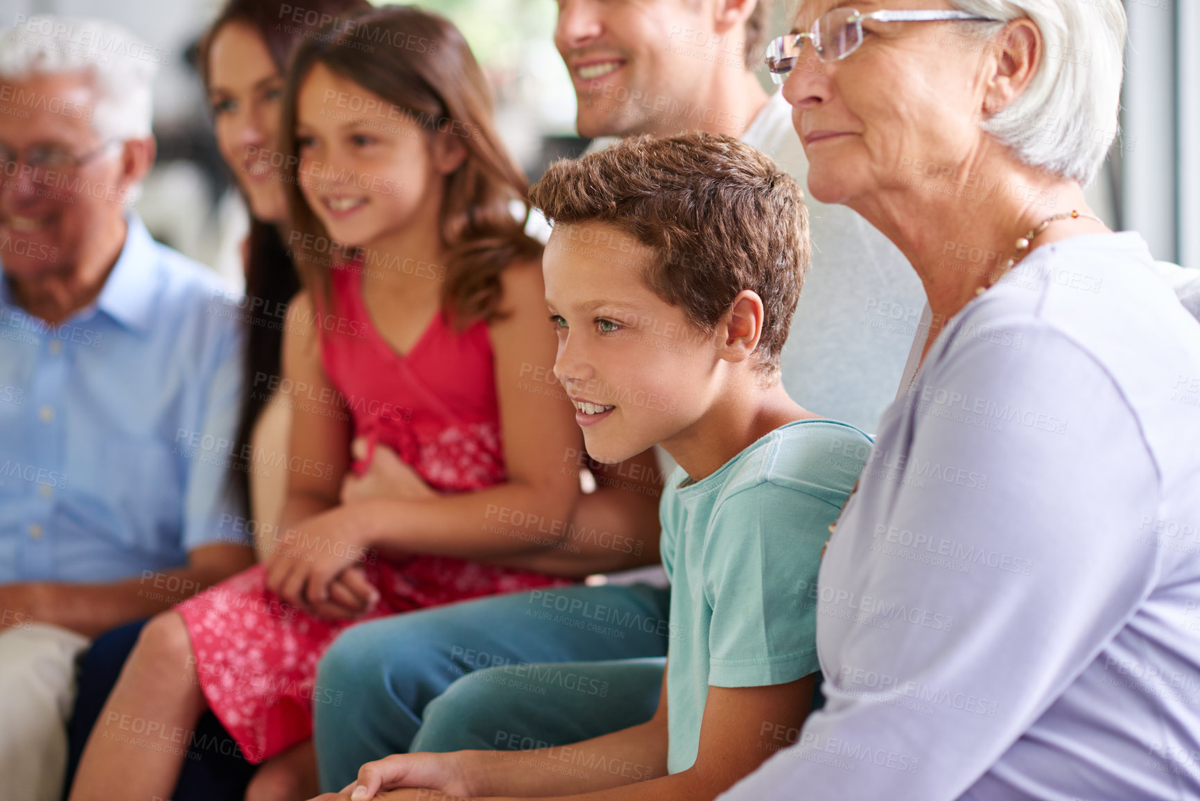 Buy stock photo Boy, child and big family in home for watching tv, relax and happy in living room with bonding for love. Kids, parents and grandparents with streaming, video and movies with subscription in lounge