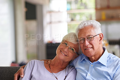 Buy stock photo Smile, portrait and senior couple on couch with love, relax or happy marriage in retirement together in home. Embrace, elderly man and woman on sofa with smile, support or care in morning bonding