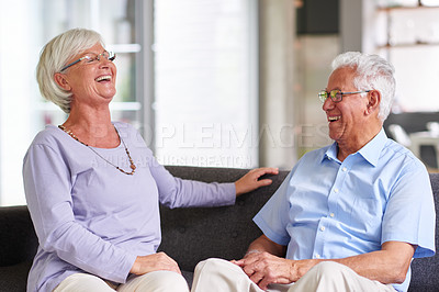 Buy stock photo Home, senior couple and happy on sofa in living room with conversation, bonding and support. People, relationship and smile as pensioners on retirement on couch on break for love, care and trust