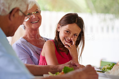 Buy stock photo Home, grandparents and girl with food for dinner, brunch and bonding together as family with meal. Happy people, woman or man with joyful child in portrait, nutrition or vegetables as healthy cuisine