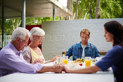 Buy stock photo Shot of a family saying grace together