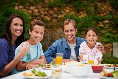 Buy stock photo Portrait of a smiling family enjoying a meal on their patio