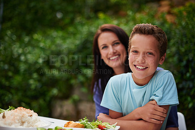 Buy stock photo Portrait of a mother and son enjoying a meal outside