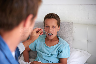 Buy stock photo Father, sick boy and medicine with spoon in bed for fever, pain relief or viral infection at home. Dad, son or child with medication, antibiotic or syrup for cough, virus or cold and flu in bedroom