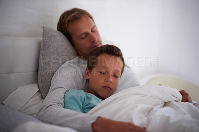 Buy stock photo A father and son sleeping in the same bed