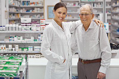 Buy stock photo Portrait of a young pharmacist helping an elderly customer at the prescription counter