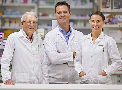 Buy stock photo Portrait of  three pharmacists standing at a counter
