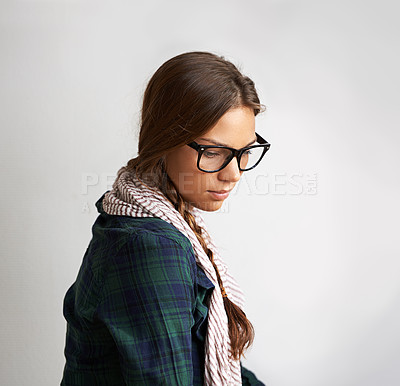 Buy stock photo Thinking, fashion and a woman on a studio background for an idea, depression or mental health. Glasses, anxiety and a young girl looking stylish, trendy and sad with a thought, plan or vision