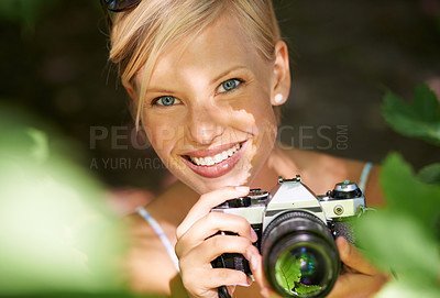Buy stock photo Portrait, photographer and camera lens with woman in forest for trees, environment and relax. Shooting, nature and photography with face of female person in woods for travel, tourism and summer