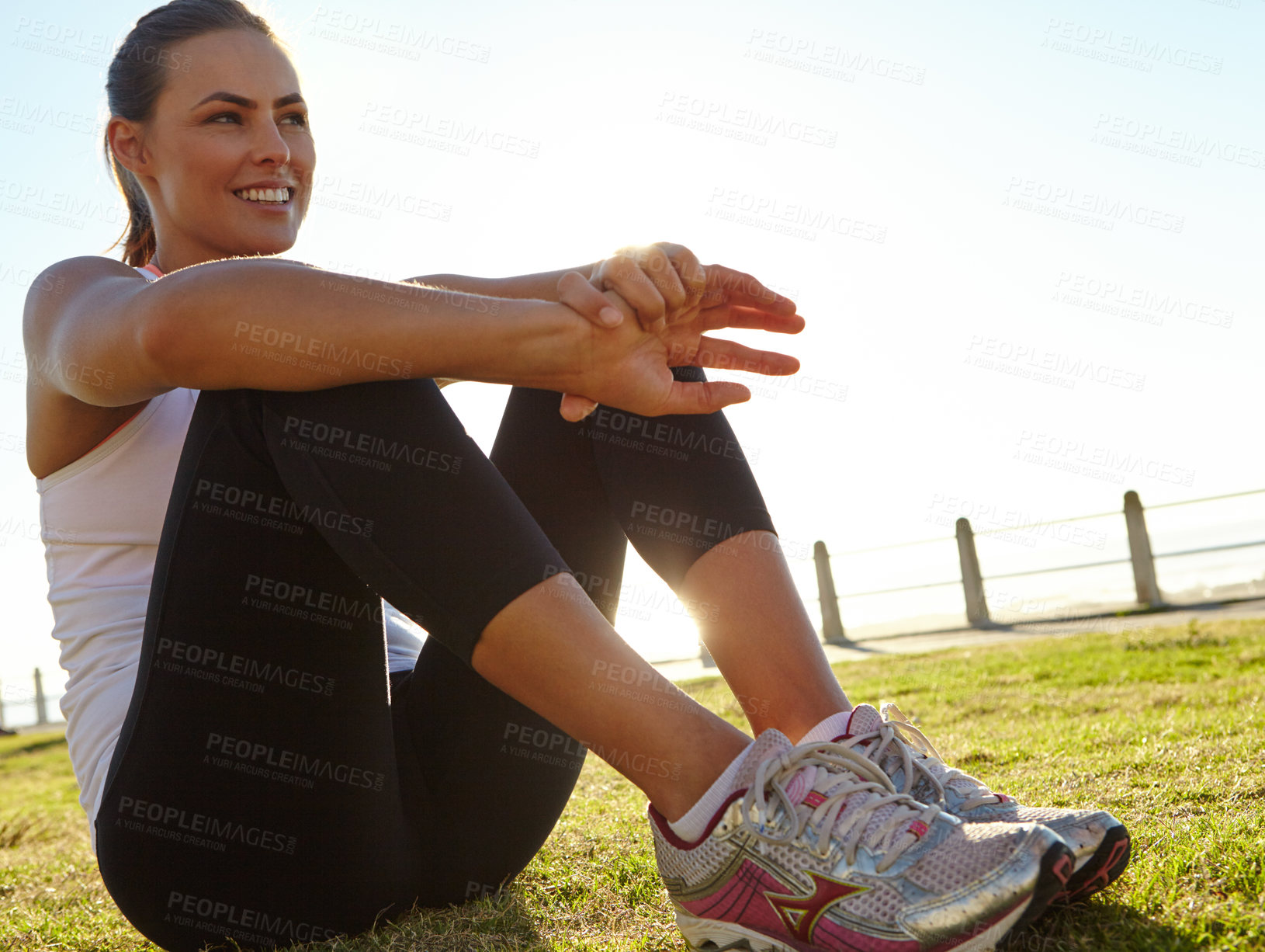 Buy stock photo Shot of a woman in sportswear resting on the grass