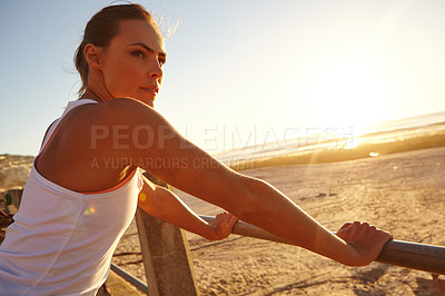 Buy stock photo Shot of a beautiful woman taking a break after her jog