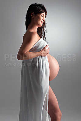 Buy stock photo A pregnant woman holding her tummy