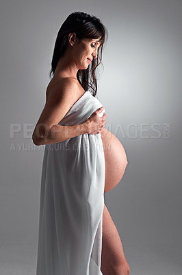 Buy stock photo Studio, pregnant and woman with love for stomach, growth and health of baby, body and glow with cosmetics. Grey background, mom and child in belly or abdomen, shine and skincare for parent and skin