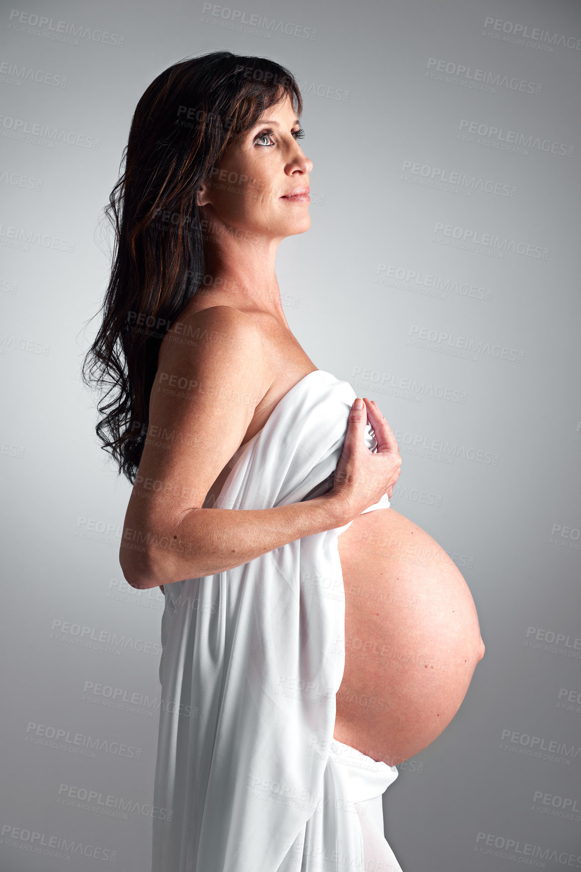 Buy stock photo Studio, pregnant and woman with hope for stomach, growth and health of baby, body and glow with cosmetics. Grey background, mom and child in belly or abdomen, shine and skincare for parent and love