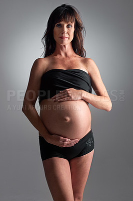 Buy stock photo A pregnant woman holding her tummy