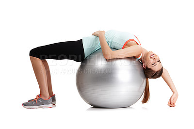Buy stock photo Shot of a fit  young woman exercising with her exercise ball isolated on white