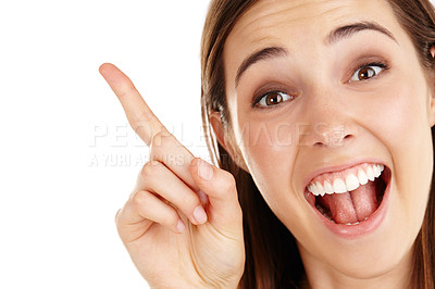 Buy stock photo Studio shot of a beautiful young woman pointing towards copyspace against a white background 