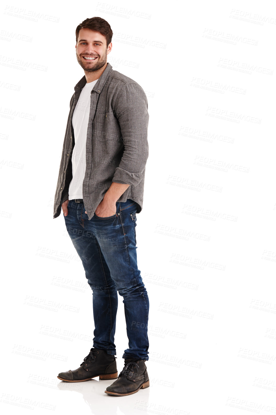 Buy stock photo Full length studio shot of a smiling young man standing with his hands in his pockets
