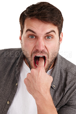 Buy stock photo Closeup studio portrait of a young man putting his finger into his mouth to suggest throwing up