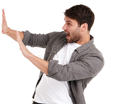 Buy stock photo Studio shot of a young man holding up his hands trying to stop something