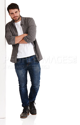 Buy stock photo Full length studio shot of a handsome young man with his arms folded leaning against a board