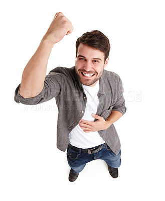 Buy stock photo High-angle shot of a happy young man in studio raising his fist in victory