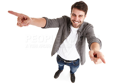 Buy stock photo High-angle shot of a happy young man in a studio raising his arms and pointing