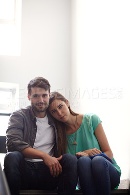 Buy stock photo Shot of a man and woman sitting together in a stairwell