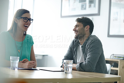 Buy stock photo Shot of colleagues sharing humorous moment in an office