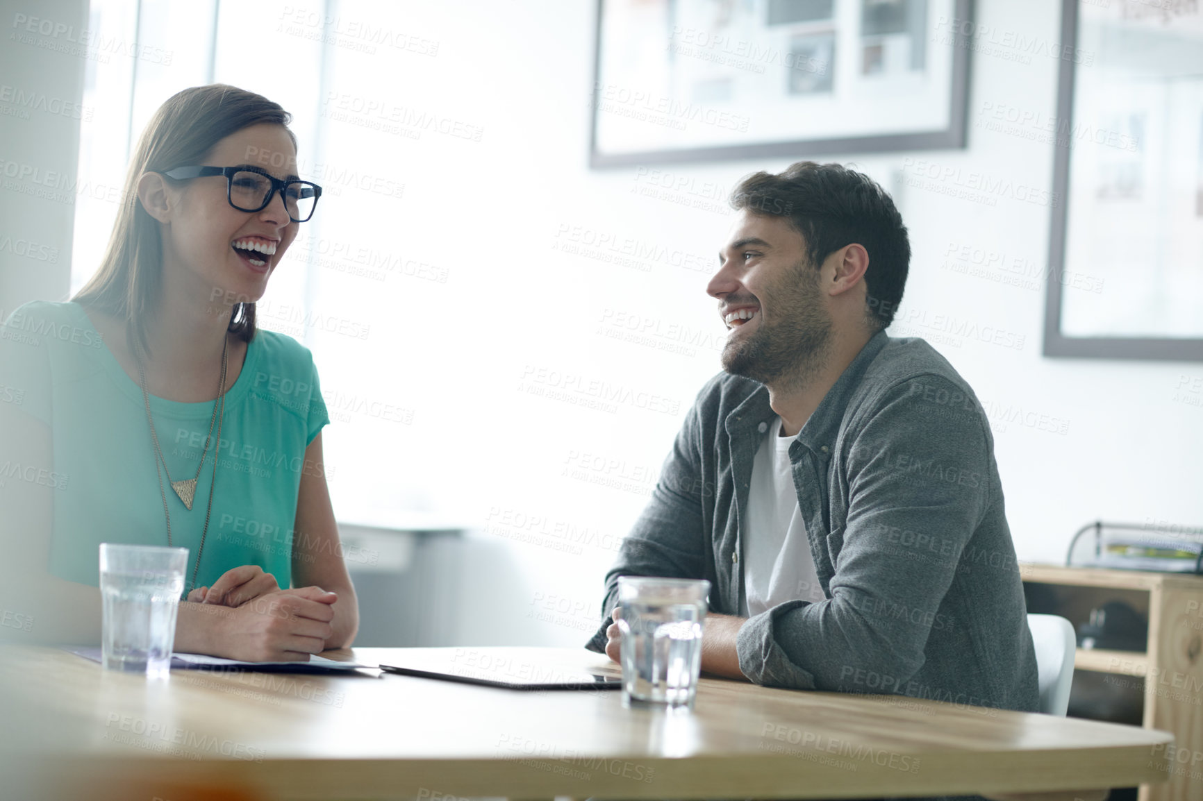 Buy stock photo Shot of colleagues sharing humorous moment in an office