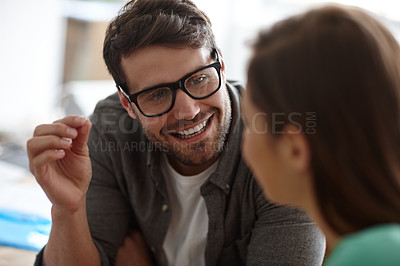 Buy stock photo Shot of a young designer carefully explaining something to a colleague