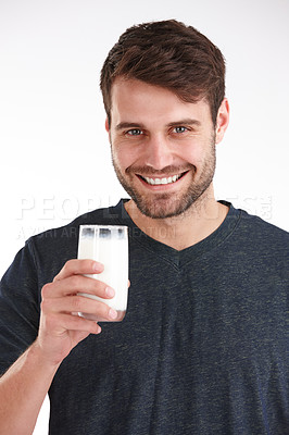Buy stock photo Studio portrait of a smiling man holding a glass of milk