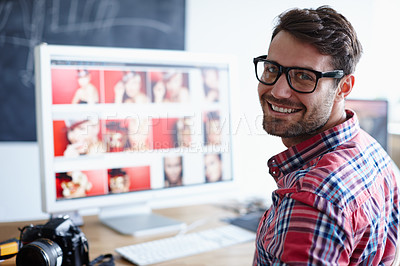 Buy stock photo Portrait shot of a creative professional at his desk working at his computer