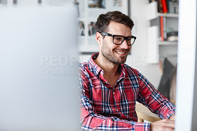 Buy stock photo Shot of a creative professional at his desk working at his computer