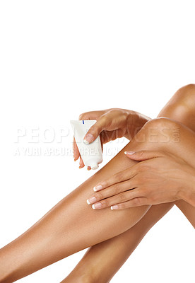 Buy stock photo Legs, hands and woman with cream product in studio on a white background. Skincare, makeup cosmetics and female model apply lotion, moisturizer or creme tube for beauty, healthy skin and wellness.
