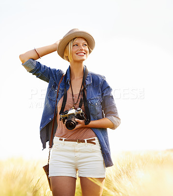 Buy stock photo Field, photographer and woman with a camera, summer and thinking with nature, picture and memory. Person, vacation and girl with photography, tourism and journey with sunshine, holiday and travel