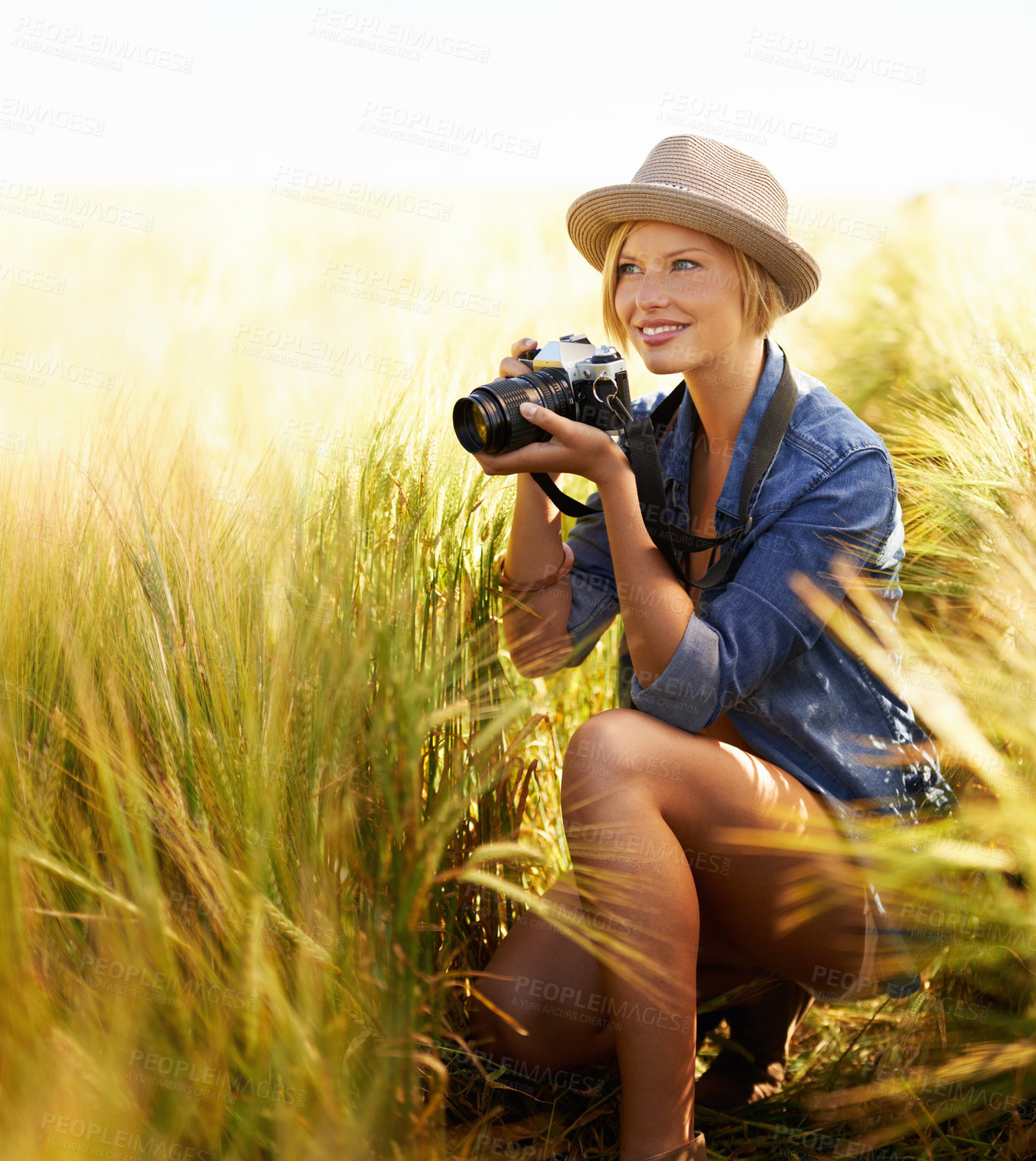 Buy stock photo Sunshine, countryside and woman with a camera, photographer and freedom with tourism, travelling and nature. Person, photography or girl with vacation, thinking or journey with picture or creative