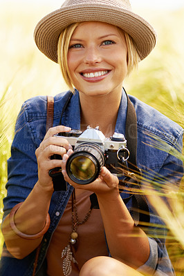 Buy stock photo Outdoor, photographer and woman with a camera, portrait and smile with nature, travel and memory with sunshine. Person, countryside or face with photography, field and journey with picture or summer