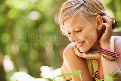 Buy stock photo Shot of an attractive young woman outdoors on a summer day