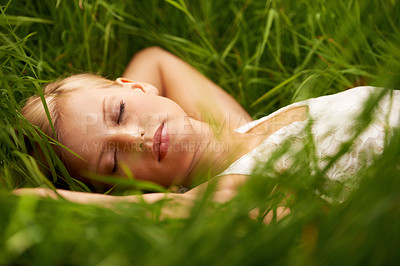 Buy stock photo Nature face, grass field and relax woman sleep, tired or leisure for outdoor wellness, calm wellbeing or countryside peace. Girl dream, freedom and park break with green lawn, pitch or garden growth