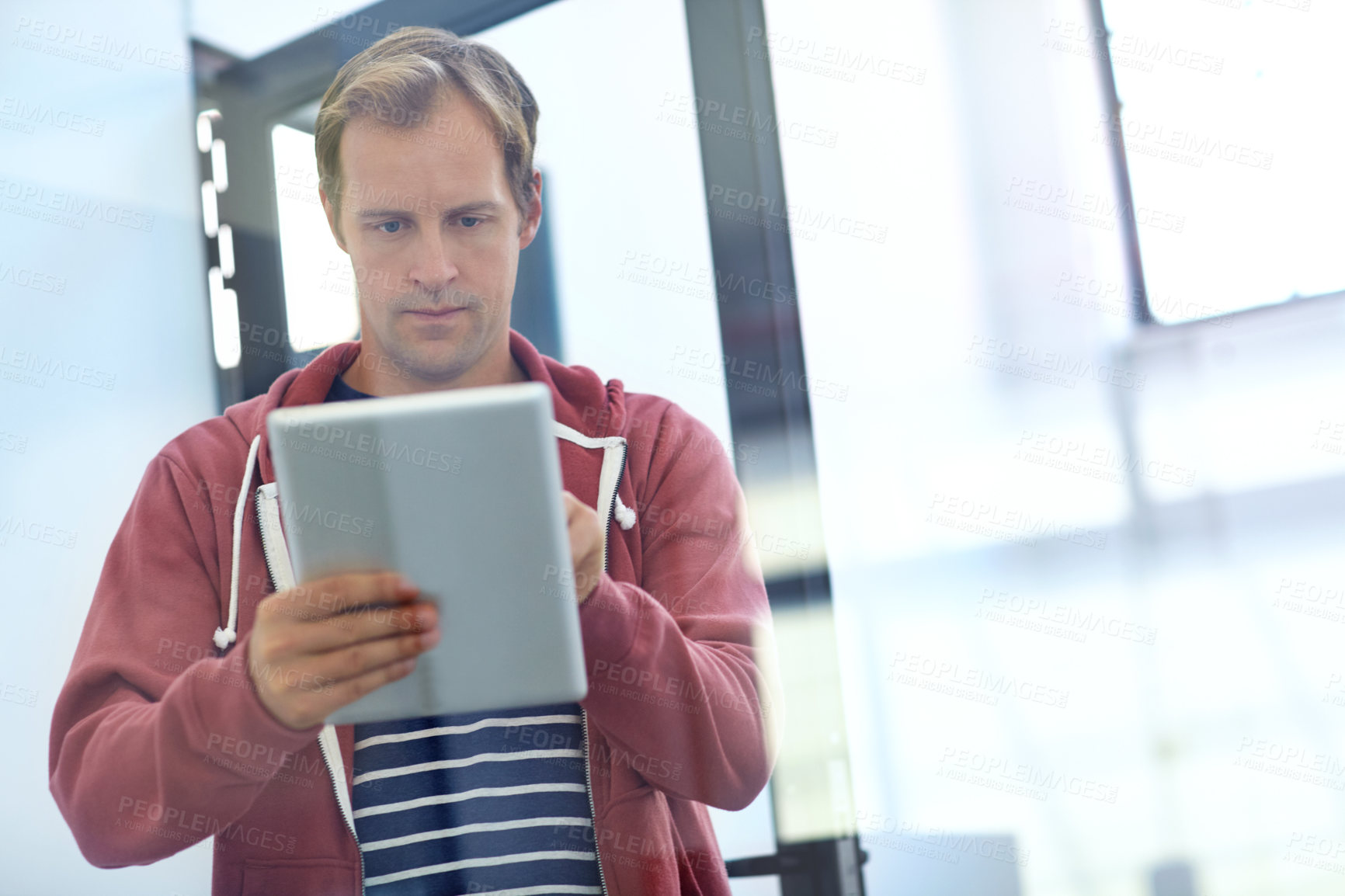 Buy stock photo Journalism, startup or man by door with tablet, reading email or deadline schedule for article draft. Review agenda, proofreading story or journalist with tech for editing, research ideas or submit