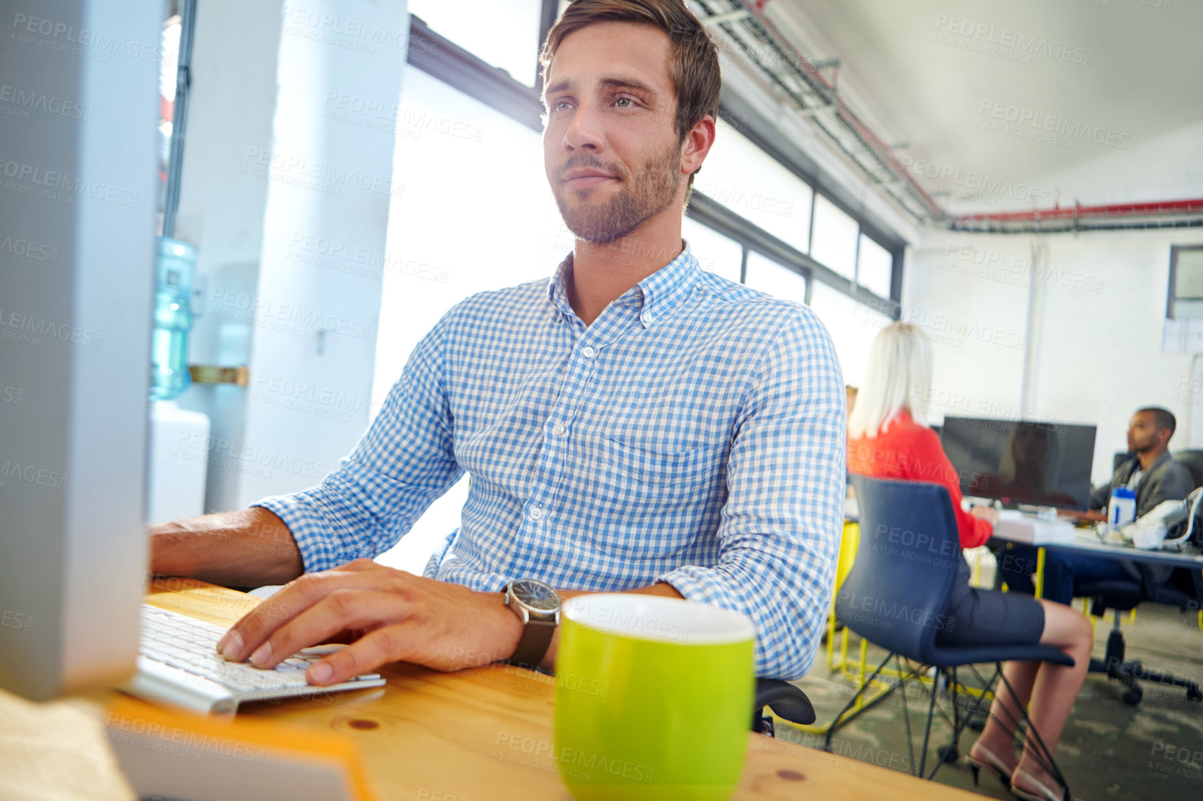 Buy stock photo Shot of a designer at work on a computer in an office