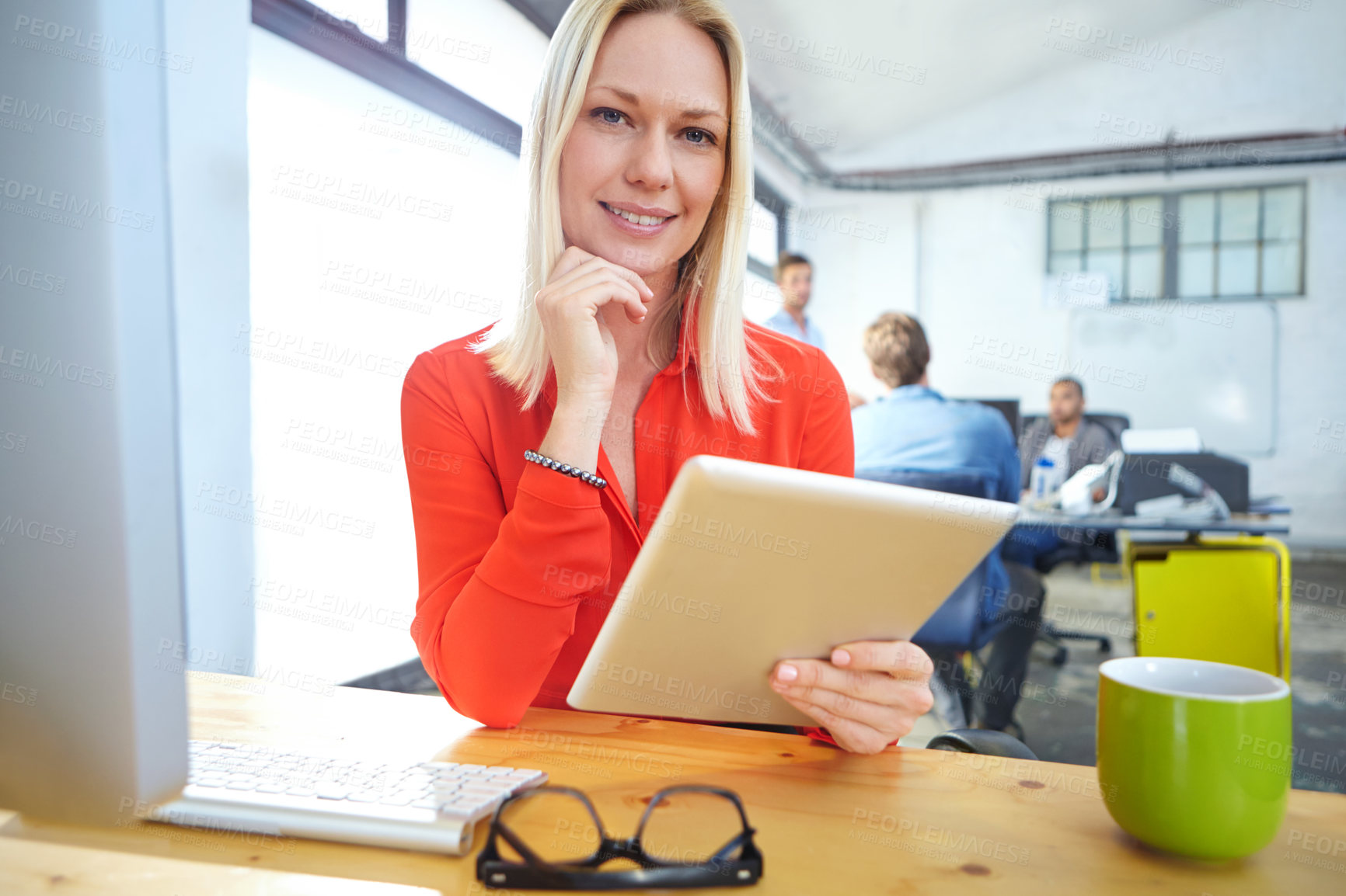 Buy stock photo Shot of a designer using a digital tablet while working in an office