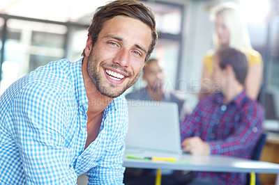 Buy stock photo Portrait of a young designer with colleagues in the background