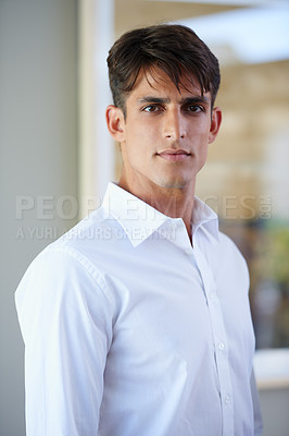 Buy stock photo Portrait of a handsome young businessman standing indoors