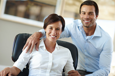 Buy stock photo Shot of an attractive woman sitting in a chair with her boyfriend beside her