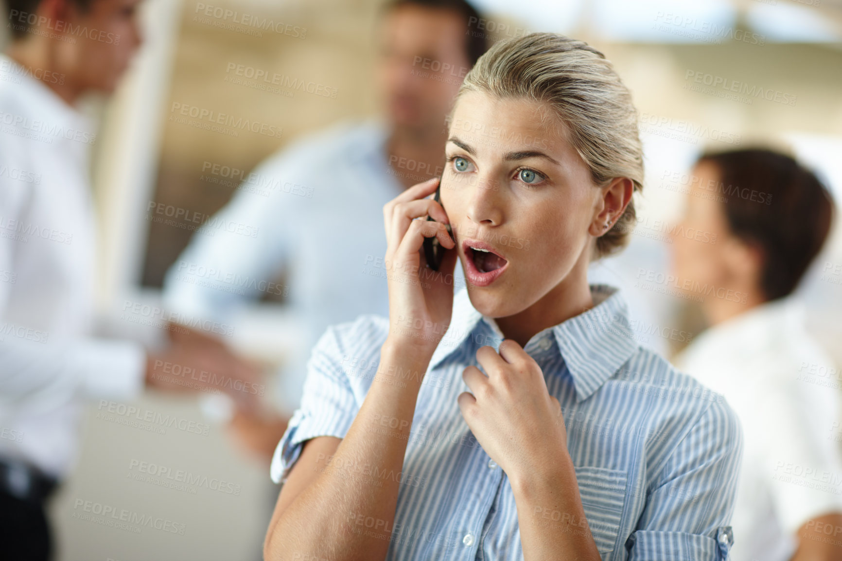 Buy stock photo Shot of a young businesswoman looking shocked while on the phone at the office