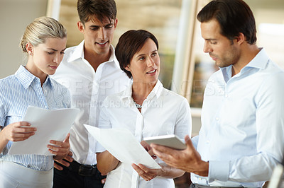 Buy stock photo Shot of a group of business colleagues working together in the office